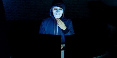 masked-hacker-using-computer-to-hack-into-system-a-2022-12-16-09-54-22-utc